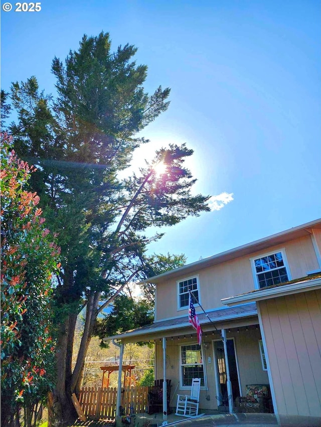 view of front of property featuring fence and covered porch