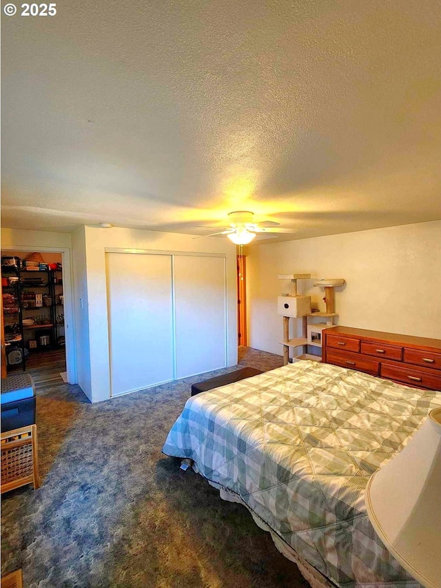 carpeted bedroom with a closet and a textured ceiling