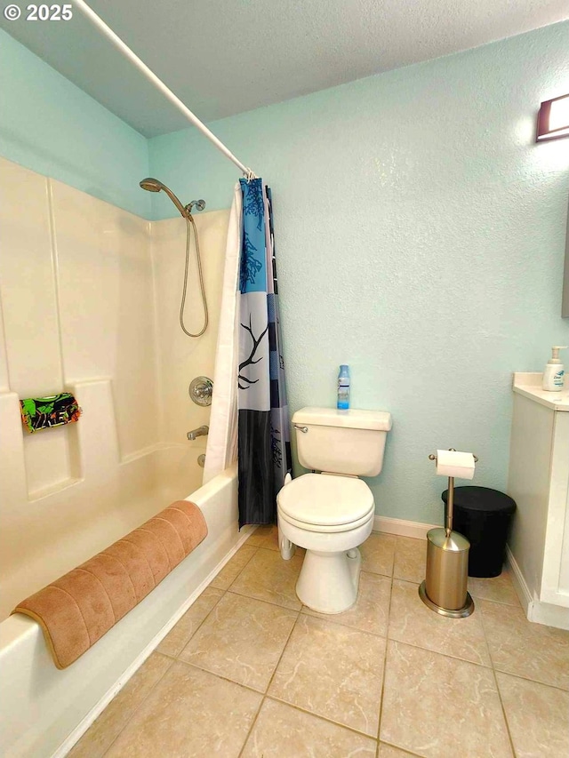 bathroom with baseboards, toilet, shower / bath combo with shower curtain, tile patterned floors, and vanity