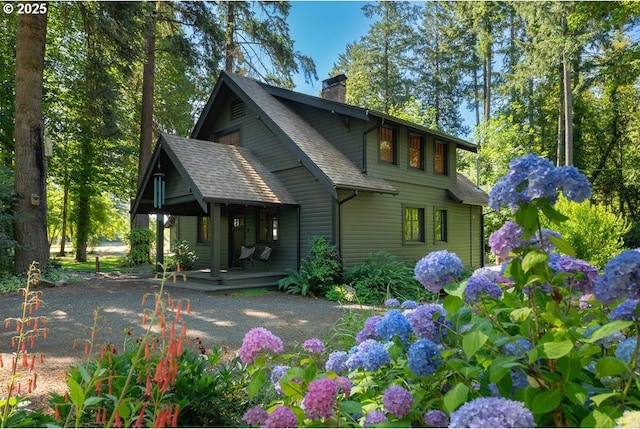 2517 Wild River Dr, Roseburg, OR 97470 - back of house featuring covered porch, a chimney, and a shingled roof