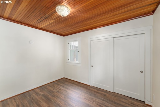 2517 Wild River Dr, Roseburg, OR 97470 - unfurnished bedroom with crown molding, baseboards, dark wood-style floors, wood ceiling, and a closet