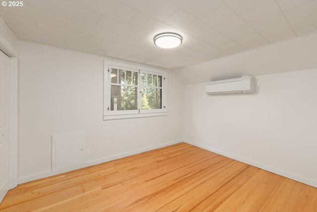 2517 Wild River Dr, Roseburg, OR 97470 - interior space with baseboards, a wall mounted AC, vaulted ceiling, and hardwood / wood-style floors