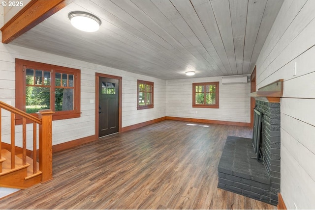2517 Wild River Dr, Roseburg, OR 97470 - unfurnished living room with stairs, a brick fireplace, wood finished floors, baseboards, and a wall mounted AC