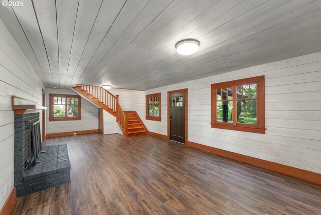 2517 Wild River Dr, Roseburg, OR 97470 - unfurnished living room with stairs, wooden walls, baseboards, and wood finished floors