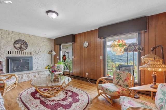 950 N Shasta Way, Clatskanie, OR 97016 - living area featuring wooden walls, wood finished floors, and a fireplace
