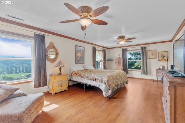 950 N Shasta Way, Clatskanie, OR 97016 - bedroom with light wood-style floors, multiple windows, baseboards, and ornamental molding
