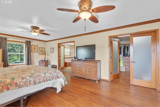 950 N Shasta Way, Clatskanie, OR 97016 - bedroom with light wood-type flooring, baseboards, ornamental molding, ceiling fan, and ensuite bath