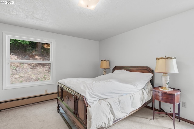 950 N Shasta Way, Clatskanie, OR 97016 - bedroom with light colored carpet, a baseboard radiator, a textured ceiling, and baseboards