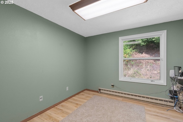 950 N Shasta Way, Clatskanie, OR 97016 - empty room with a baseboard heating unit, wood finished floors, and baseboards