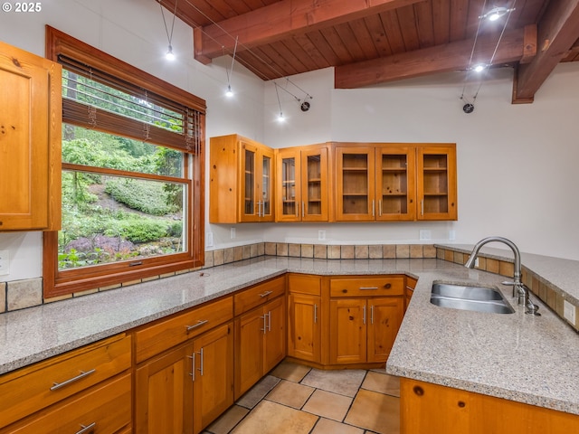 13200 NW Old Germantown Rd, Portland, OR 97035 - kitchen featuring a sink, wooden ceiling with exposed beams, brown cabinets, and light stone countertops