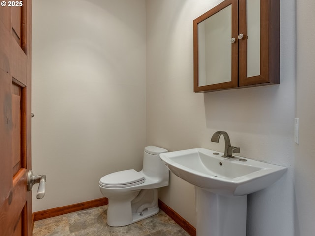 13200 NW Old Germantown Rd, Portland, OR 97035 - bathroom with baseboards, toilet, and a sink