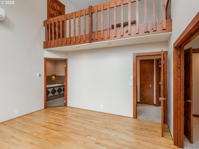 13200 NW Old Germantown Rd, Portland, OR 97035 - unfurnished living room featuring a high ceiling and wood finished floors