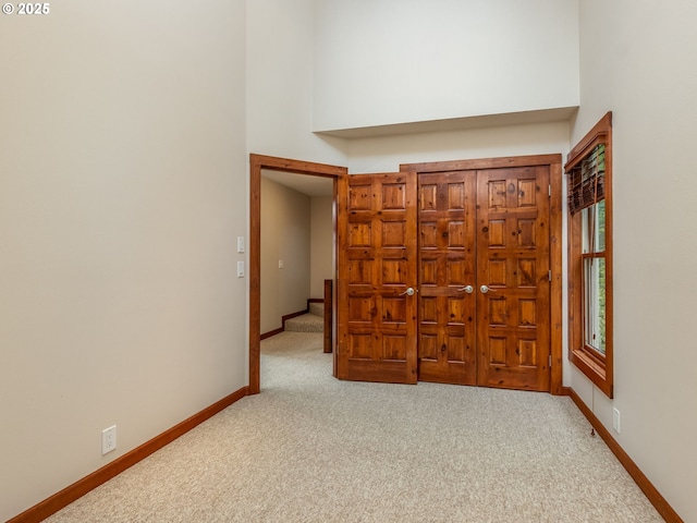 13200 NW Old Germantown Rd, Portland, OR 97035 - hall with a high ceiling, light carpet, and baseboards