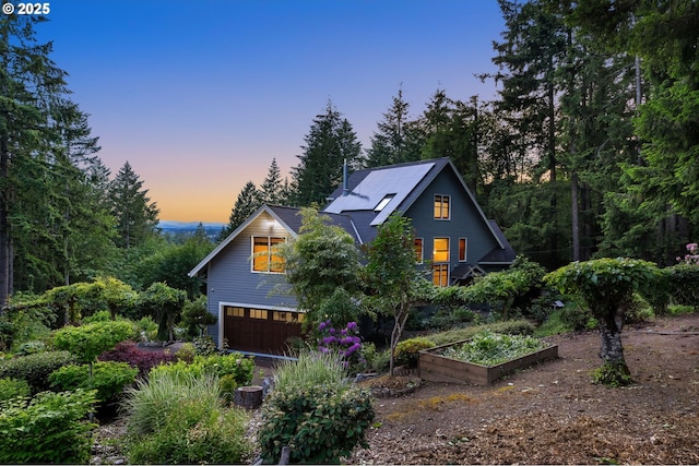 13200 NW Old Germantown Rd, Portland, OR 97035 - view of front of property featuring an attached garage and a garden