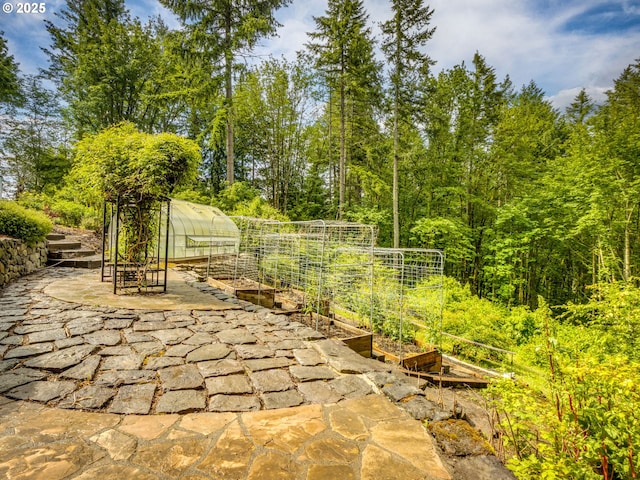13200 NW Old Germantown Rd, Portland, OR 97035 - view of patio featuring a garden, a greenhouse, and an outdoor structure