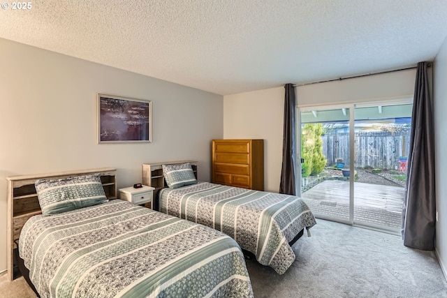 bedroom featuring access to exterior, light carpet, and a textured ceiling