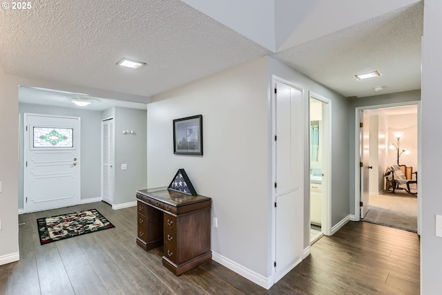 foyer featuring dark hardwood / wood-style floors and a textured ceiling