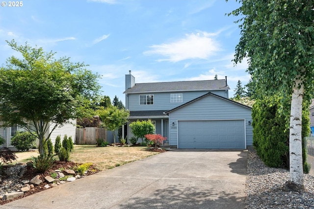 15205 NE 47th St, Vancouver, WA 98682 - traditional home featuring an attached garage, concrete driveway, and a chimney