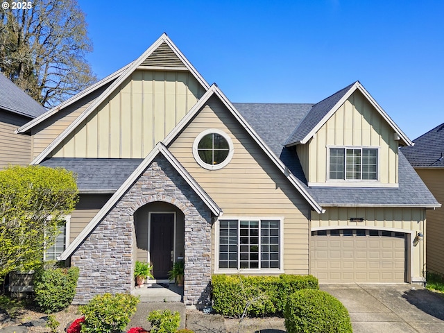 craftsman house with stone siding, board and batten siding, driveway, and roof with shingles