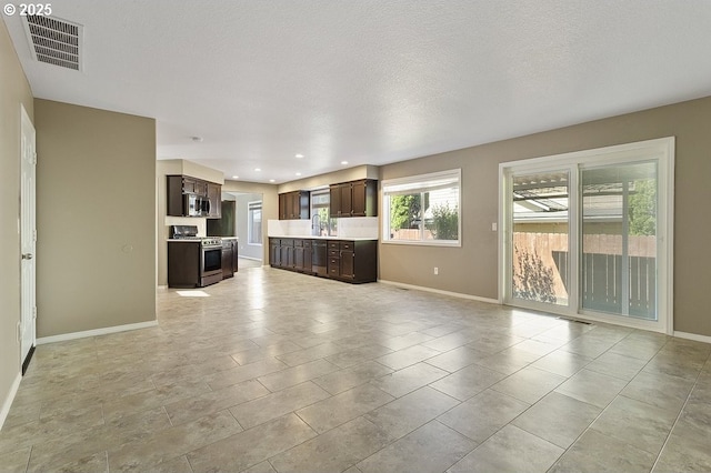 3317 SW Eastwood Ave, Gresham, OR 97080 - unfurnished living room with baseboards and recessed lighting