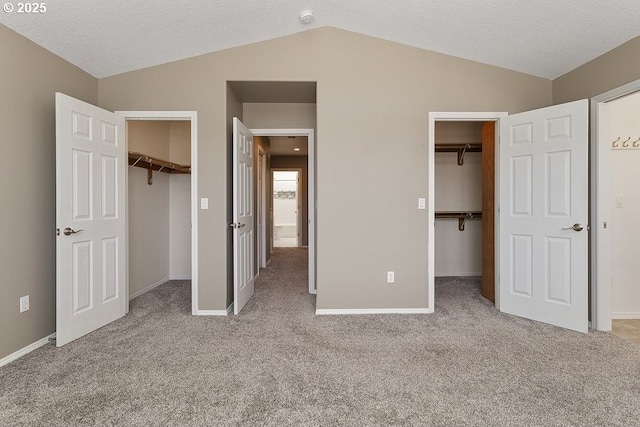 3317 SW Eastwood Ave, Gresham, OR 97080 - unfurnished bedroom featuring a walk in closet, vaulted ceiling, a closet, carpet floors, and baseboards
