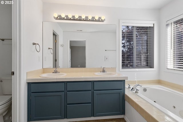 3317 SW Eastwood Ave, Gresham, OR 97080 - bathroom featuring toilet, double vanity, a whirlpool tub, and healthy amount of natural light