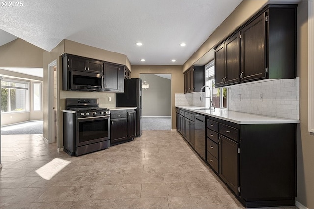 3317 SW Eastwood Ave, Gresham, OR 97080 - kitchen with appliances with stainless steel finishes, a sink, light countertops, backsplash, and baseboards