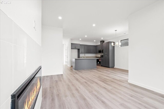 hallway with plenty of natural light, carpet, baseboards, and an upstairs landing