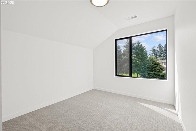 laundry room with estacked washer and dryer, baseboards, and carpet flooring