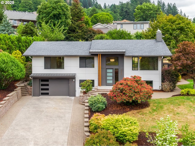 1908 50th St, Washougal, WA 98671 - view of front of house featuring a shingled roof, concrete driveway, a chimney, and an attached garage