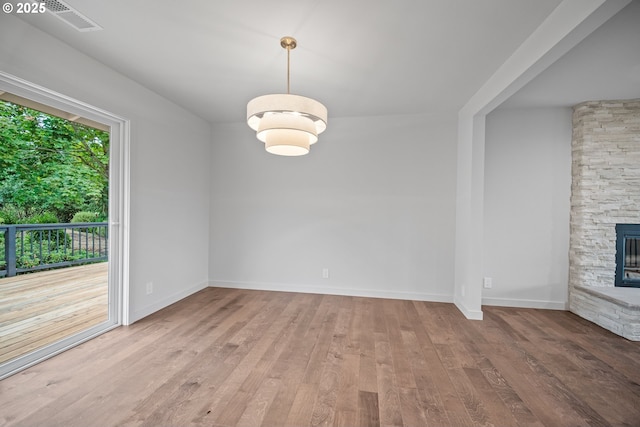 1908 50th St, Washougal, WA 98671 - unfurnished dining area featuring hardwood / wood-style floors and a fireplace