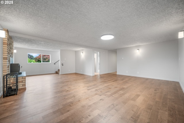 1908 50th St, Washougal, WA 98671 - unfurnished living room with wood finished floors, stairway, and a textured ceiling