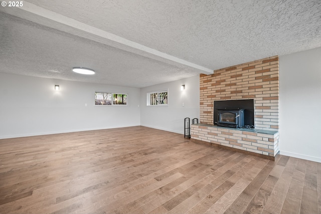1908 50th St, Washougal, WA 98671 - unfurnished living room with wood finished floors, a textured ceiling, and a fireplace