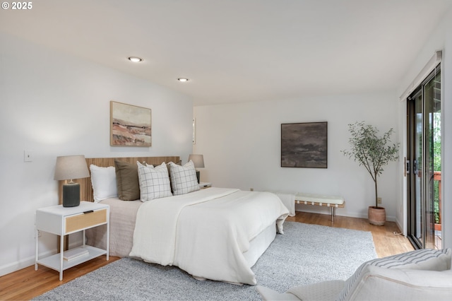 bedroom with wood finished floors, baseboards, and recessed lighting