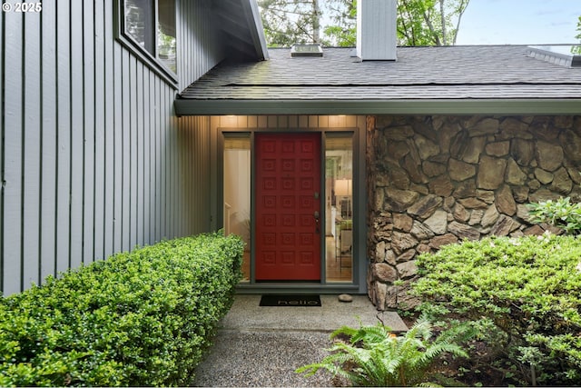 property entrance featuring stone siding