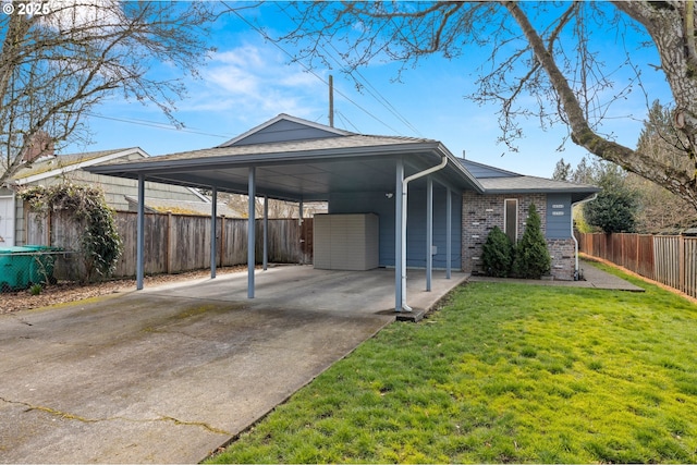 exterior space with a front yard, fence, driveway, a carport, and brick siding