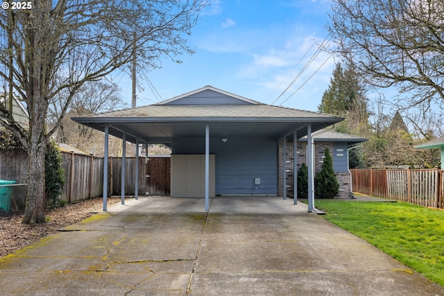 exterior space featuring a carport, concrete driveway, fence, and brick siding