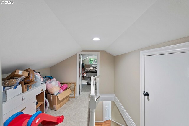 bonus room with vaulted ceiling, carpet flooring, and baseboards
