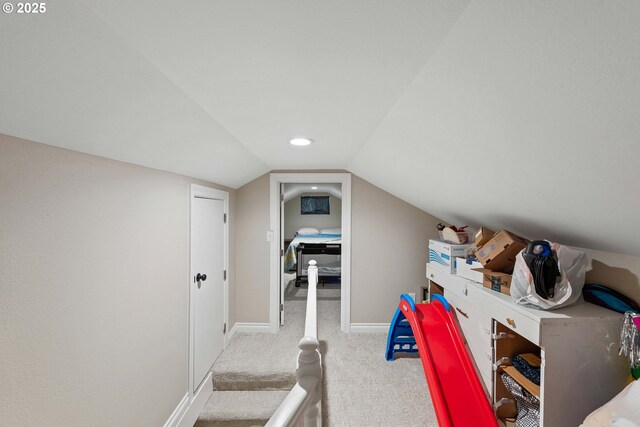 bonus room with carpet flooring, vaulted ceiling, and baseboards