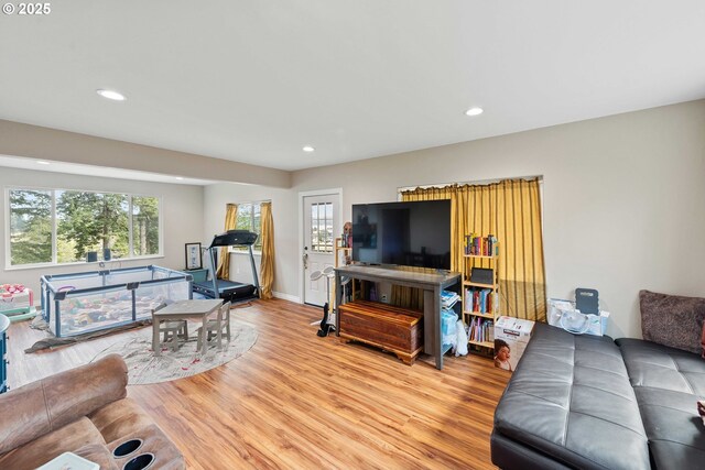living area with plenty of natural light, light wood-type flooring, recessed lighting, and baseboards