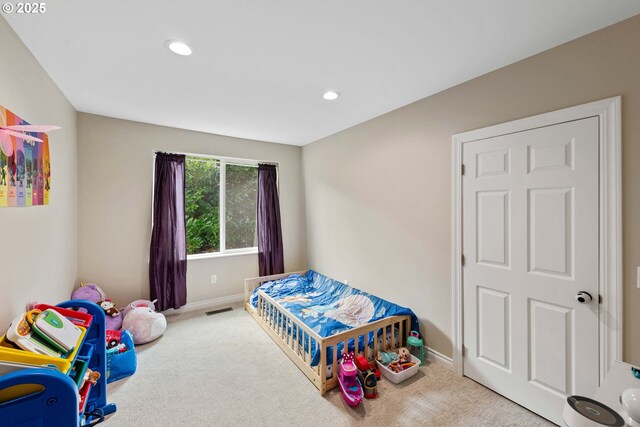 carpeted bedroom featuring baseboards and recessed lighting