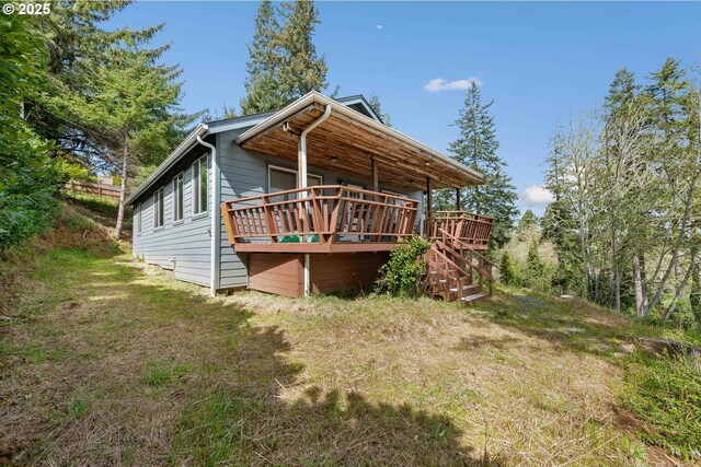 view of side of property featuring a deck and stairs