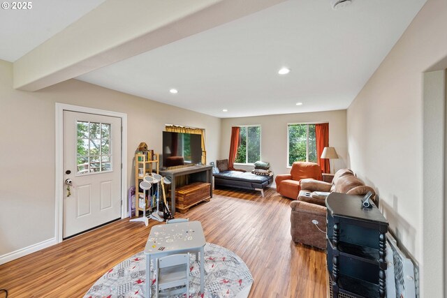 living area featuring wood finished floors, recessed lighting, and baseboards