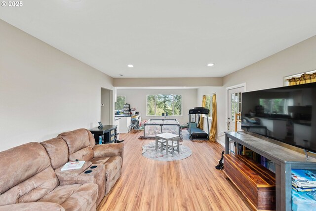 living room with light wood finished floors and recessed lighting