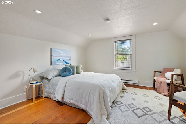 5655 SW Lombard Ave, Beaverton, OR 97005 - bedroom with lofted ceiling, a baseboard radiator, light wood-type flooring, a textured ceiling, and recessed lighting