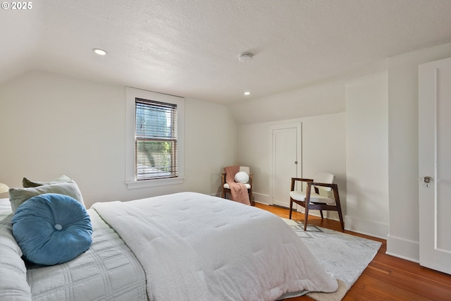 5655 SW Lombard Ave, Beaverton, OR 97005 - bedroom featuring vaulted ceiling, wood finished floors, recessed lighting, and a textured ceiling