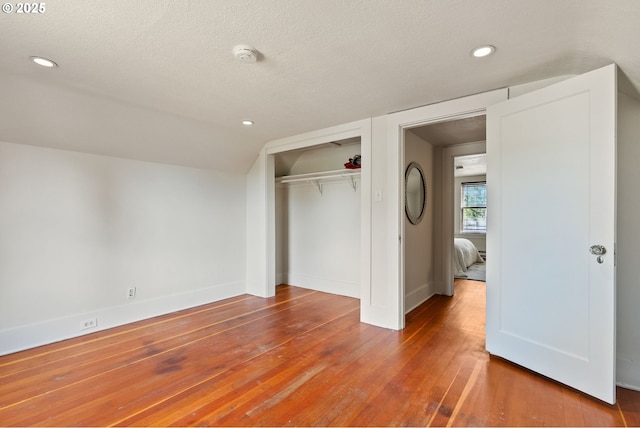 5655 SW Lombard Ave, Beaverton, OR 97005 - unfurnished bedroom with wood-type flooring, a closet, a textured ceiling, recessed lighting, and vaulted ceiling