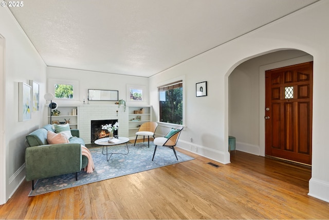 5655 SW Lombard Ave, Beaverton, OR 97005 - living room with arched walkways, wood finished floors, and plenty of natural light
