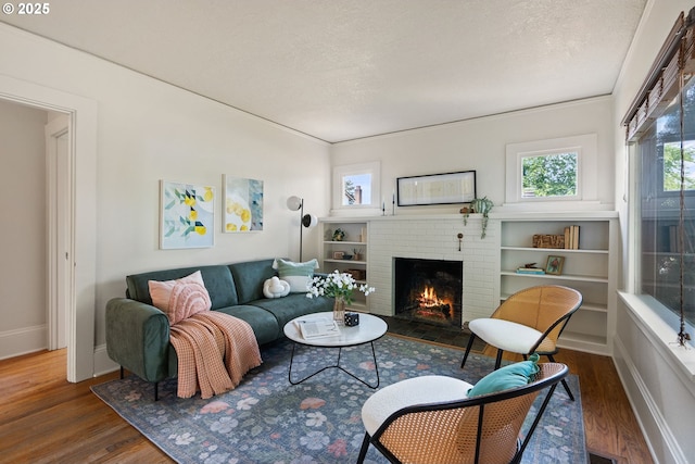 5655 SW Lombard Ave, Beaverton, OR 97005 - living room with a brick fireplace, wood finished floors, and a textured ceiling