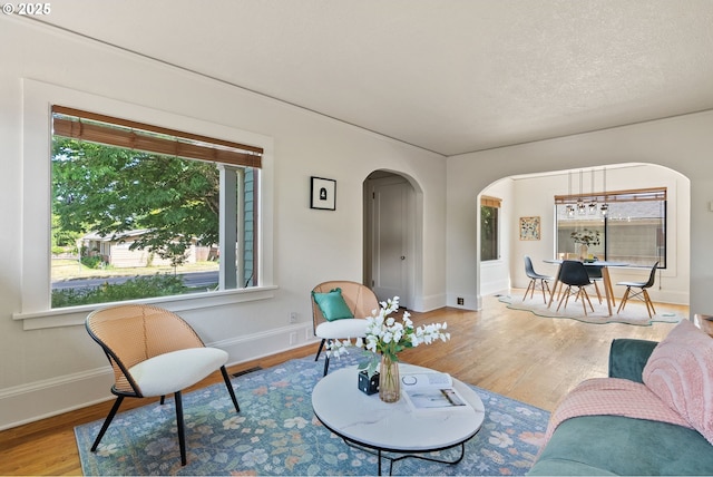 5655 SW Lombard Ave, Beaverton, OR 97005 - living area featuring arched walkways and wood finished floors
